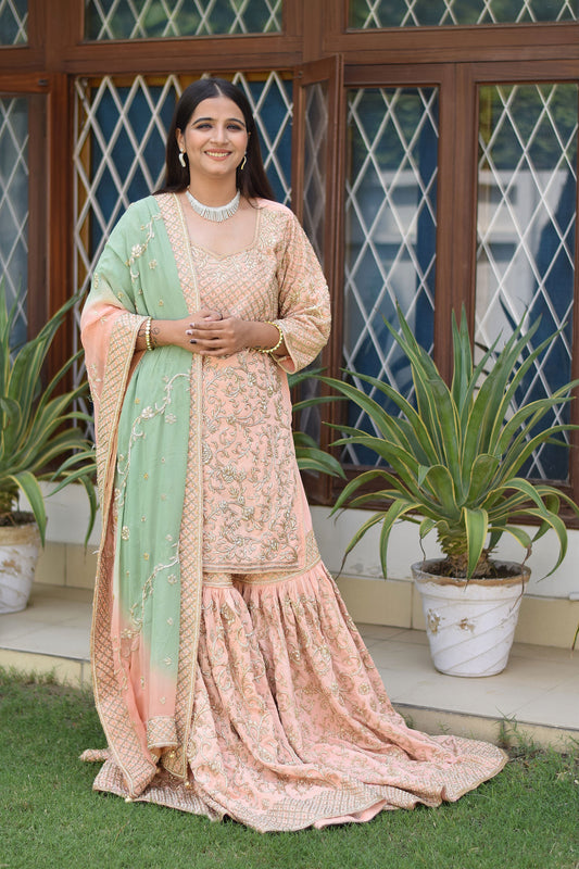 Exquisite ensemble of Woman in Peach Crepe Silk Zardozi Jaal Work Gharara Set