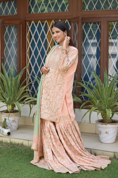 Stylish ensemble featuring Woman in Peach Crepe Silk Zardozi Jaal Work Gharara Set