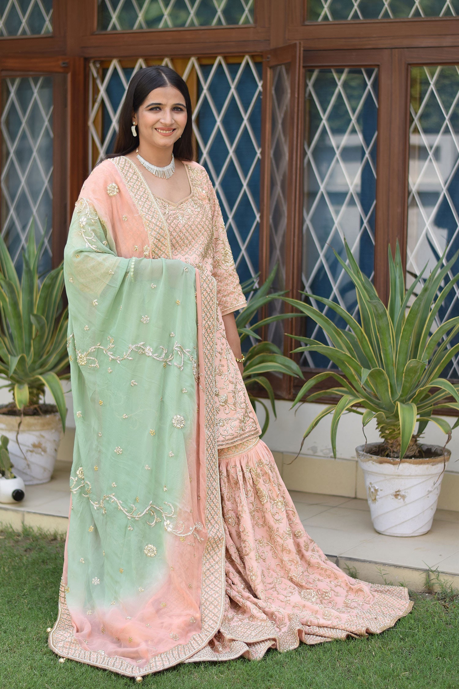 Sophisticated attire of Woman wearing Peach Crepe Silk Zardozi Jaal Work Gharara Set
