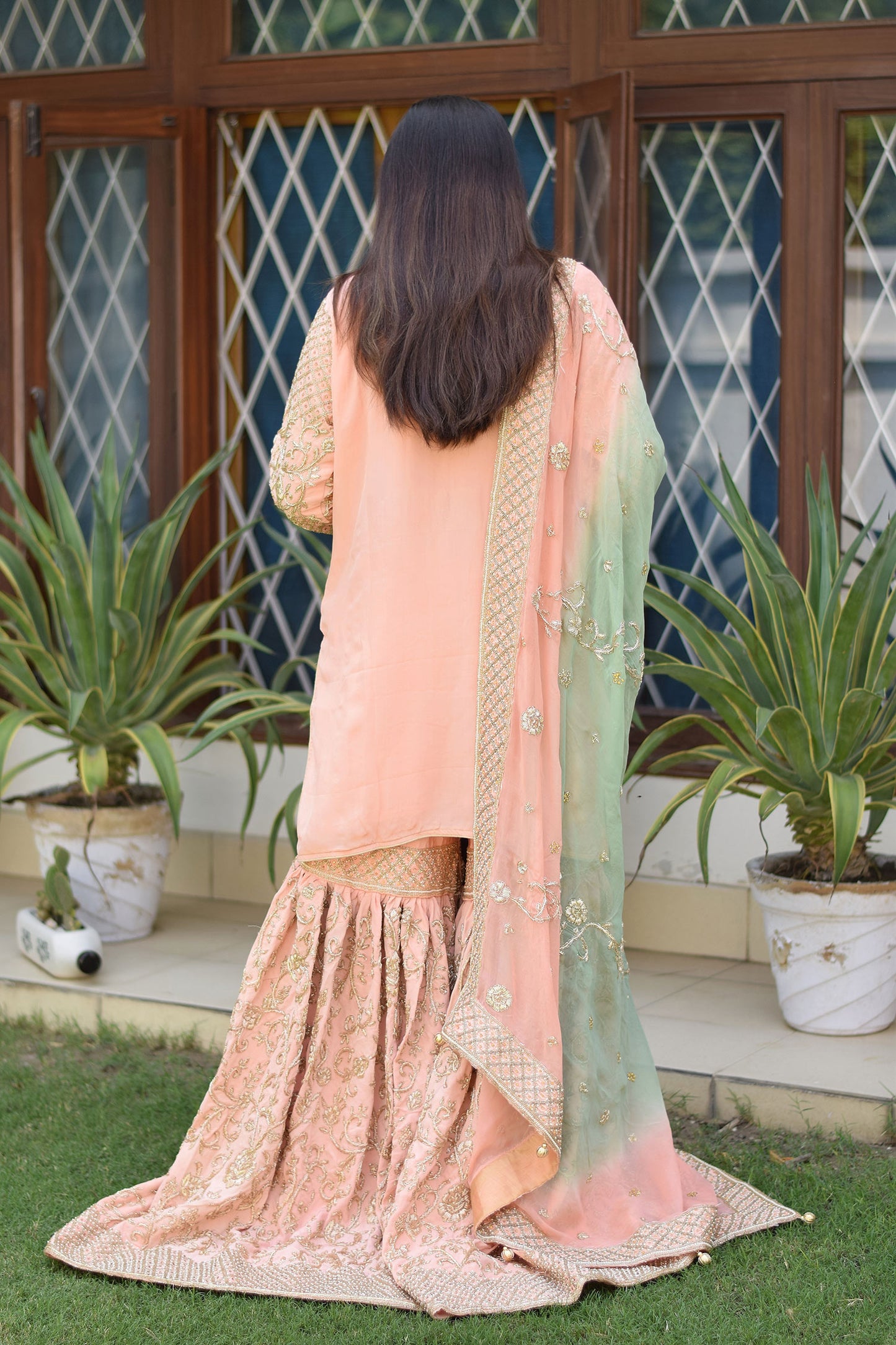 Modern look with Woman in Peach Crepe Silk Zardozi Jaal Work Gharara Set