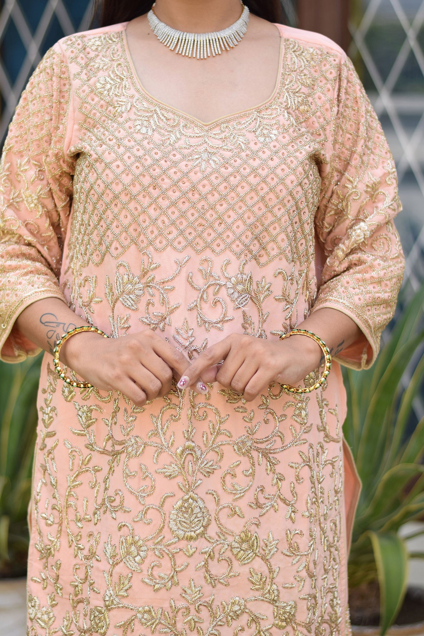 Modern look with Woman in Peach Crepe Silk Zardozi Jaal Work Gharara Set