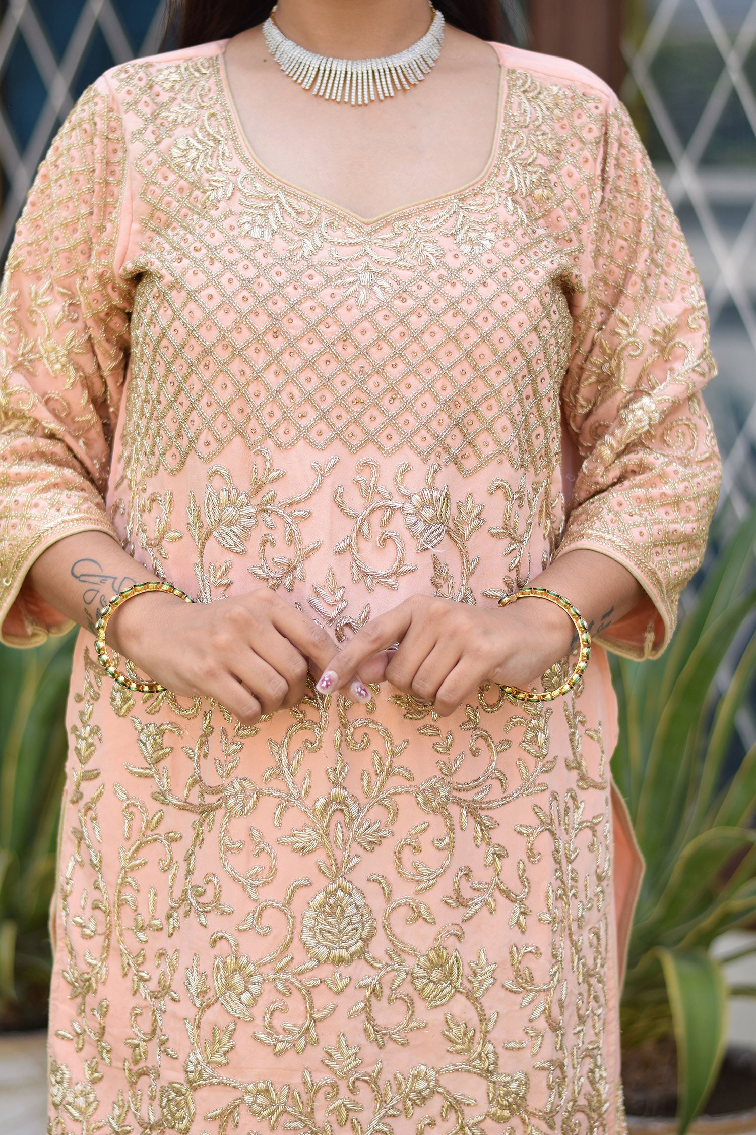 Modern look with Woman in Peach Crepe Silk Zardozi Jaal Work Gharara Set