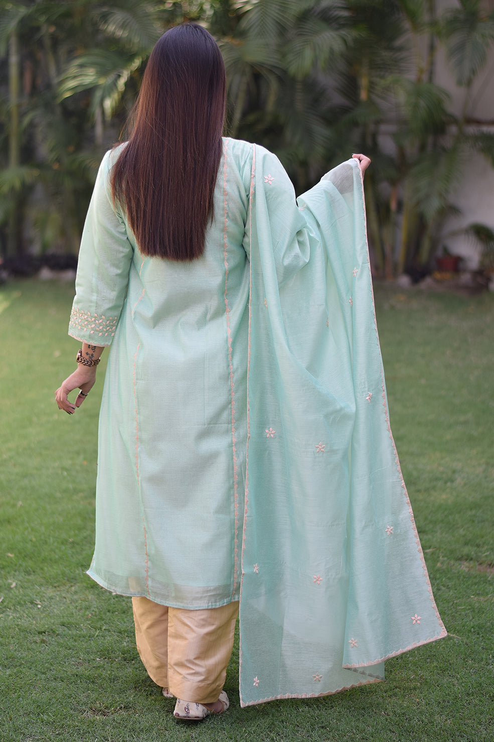 A stunning Indian lady in a sea green Aari work kurta with mirror work detailing