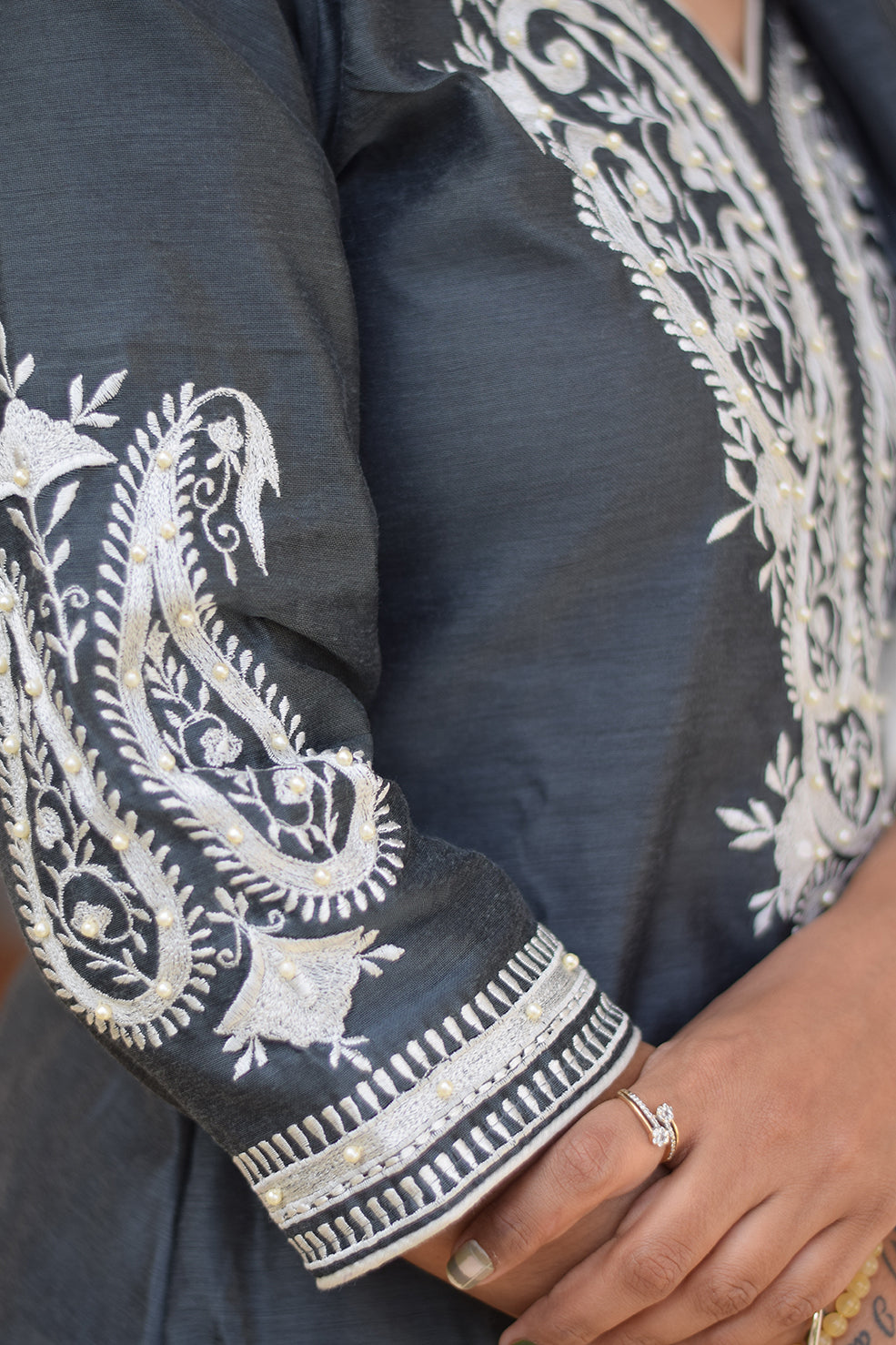 A beautiful Indian lady wearing a grey kurta dupatta set.