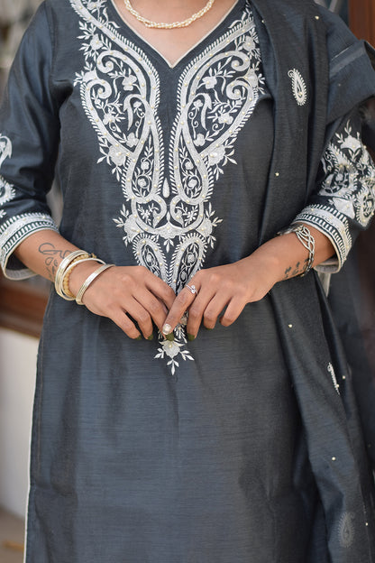 A traditional Indian grey kurta and dupatta on a woman.