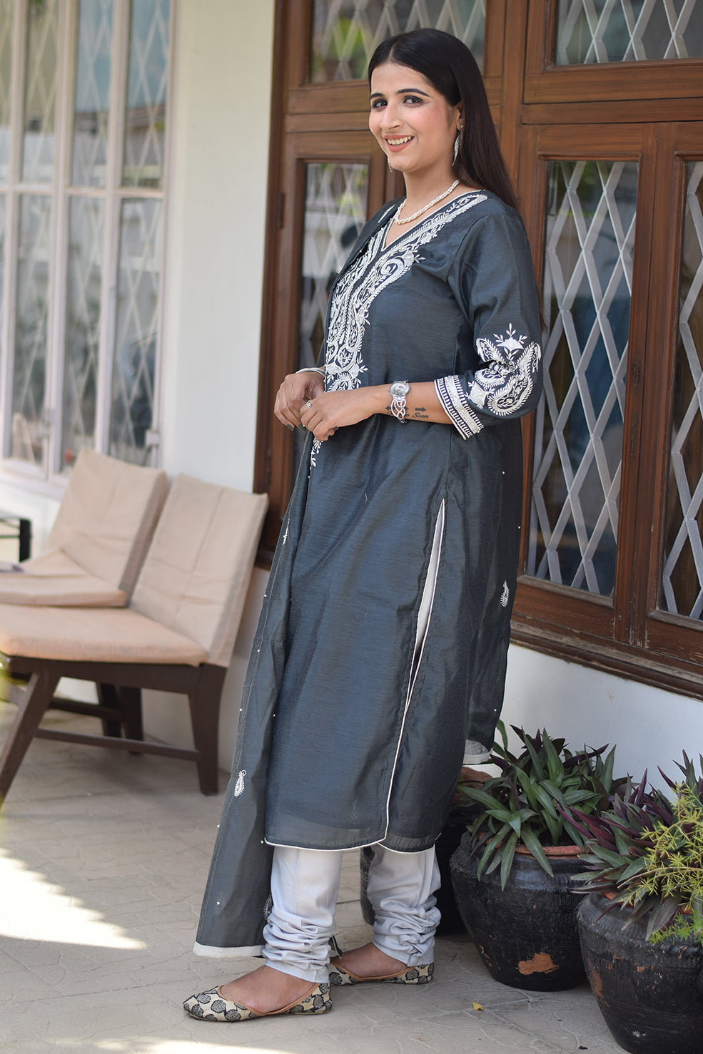 A female Indian fashion model in traditional grey attire.