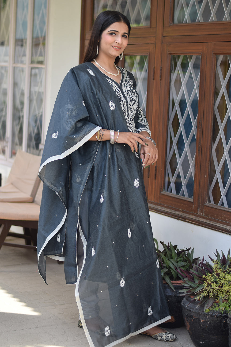 A grey kurta and dupatta set, worn by a woman from India.