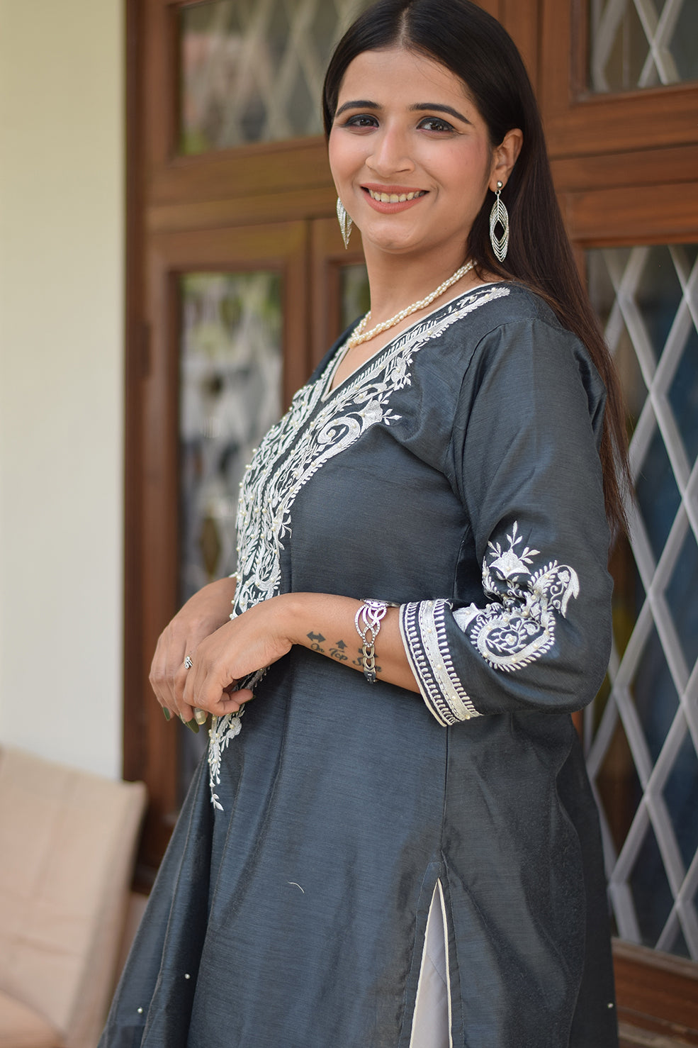 A grey kurta dupatta set worn by a woman from India.