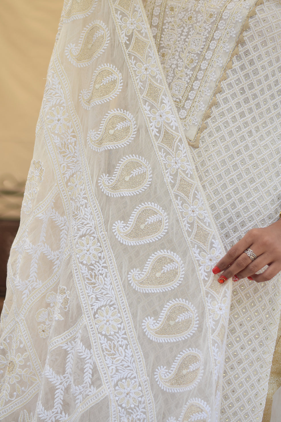 A close-up of a white georgette dupatta, showcasing the intricate chikankari embroidery with kikri and kamdani details.