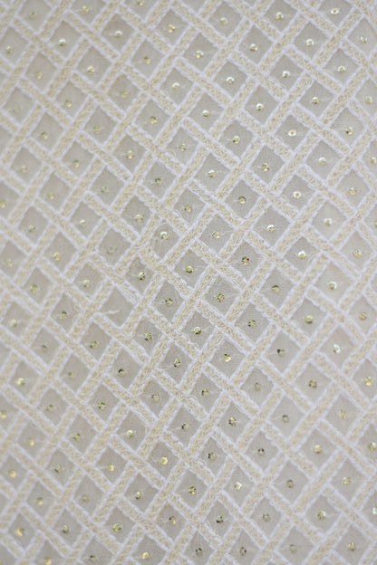 A close-up of a white georgette dupatta with intricate chikankari embroidery featuring kikri and kamdani details.