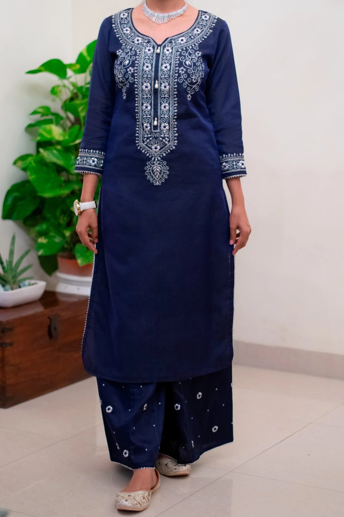 A stylish Indian woman wearing a blue kurta and a matching blue dupatta, looking elegant and confident.