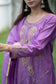 A fashionable woman is captured in this image wearing a purple lilac kurta with matching trousers.