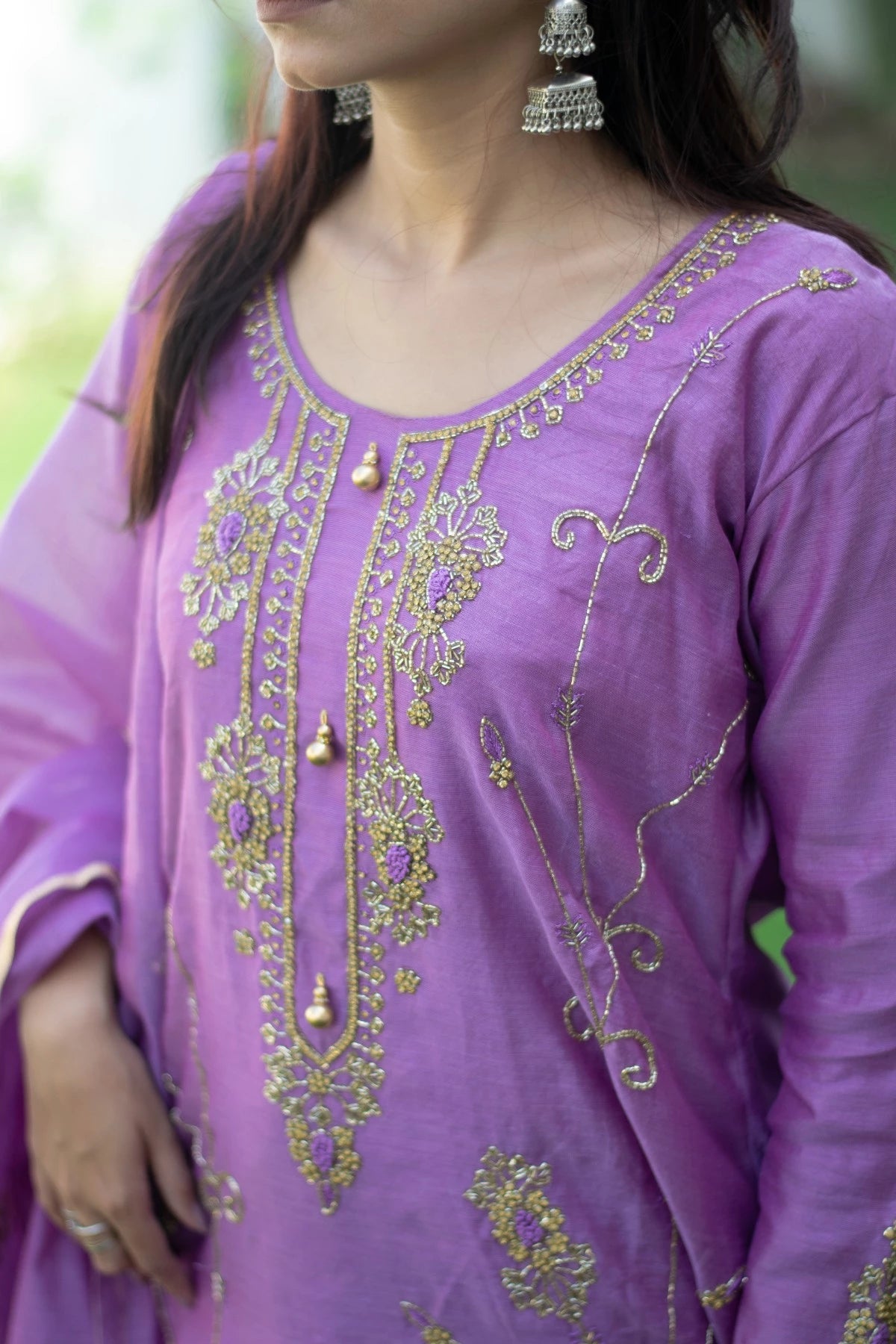 This image showcases a stylish woman wearing a purple lilac kurta and elegant trousers.