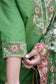 An elegant bridal outfit featuring a green silk gharara suit and kamkhab zardozi embroidery.