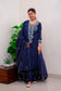 An Indian woman wearing a blue kurta and dupatta, a traditional outfit commonly worn for festive occasions and weddings.