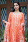 A woman wearing a bright orange silk kurta paired with trousers