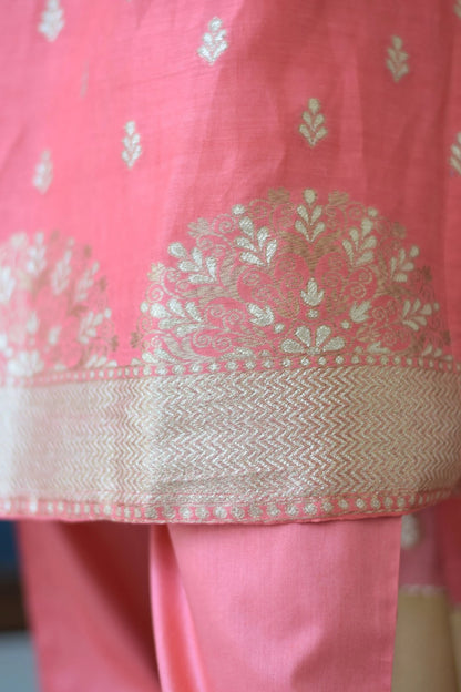 A peach-colored linen kurta with a mandarin collar and short sleeves on a woman.