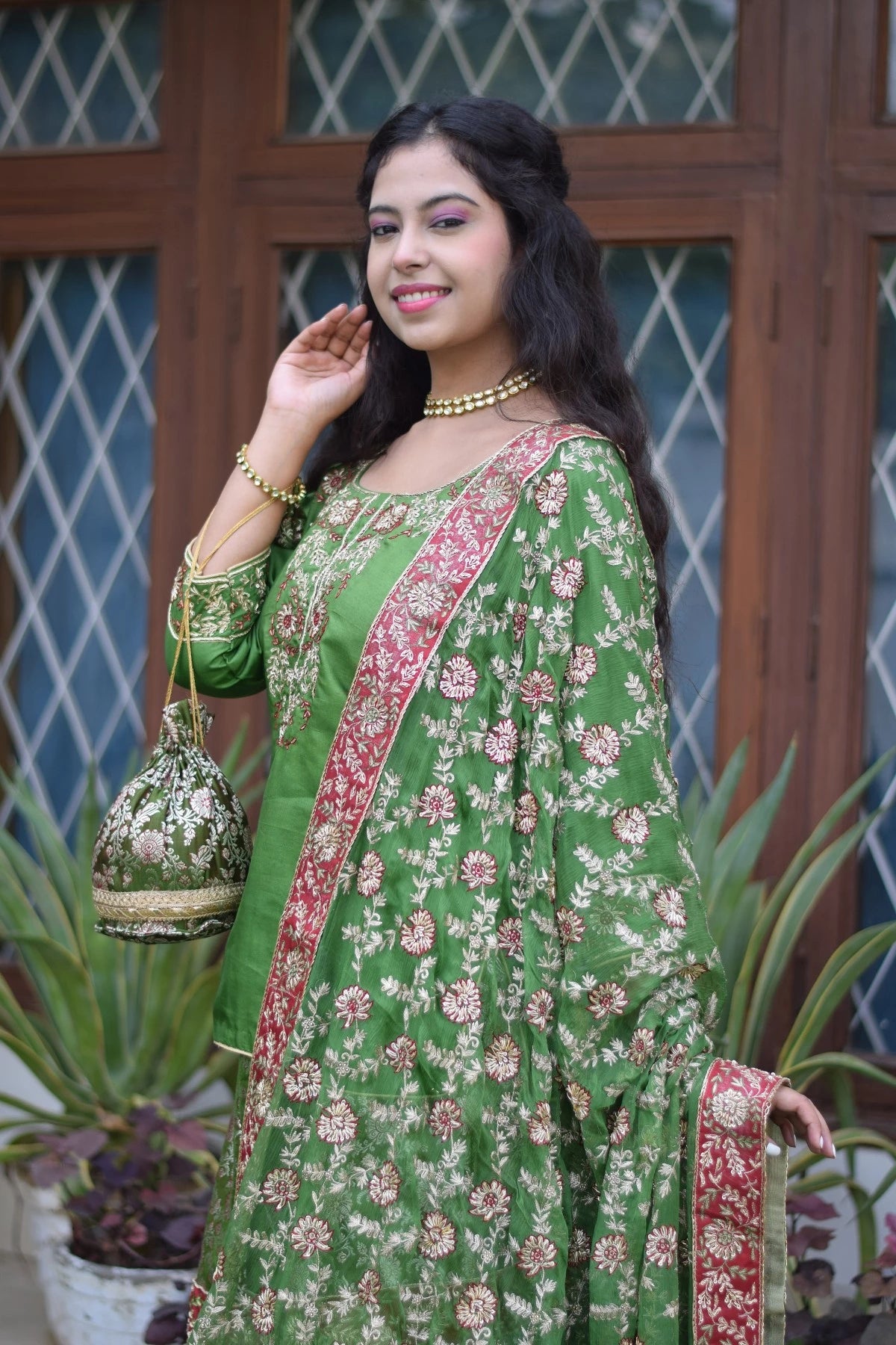 A stunning Indian bride in a green silk gharara suit.