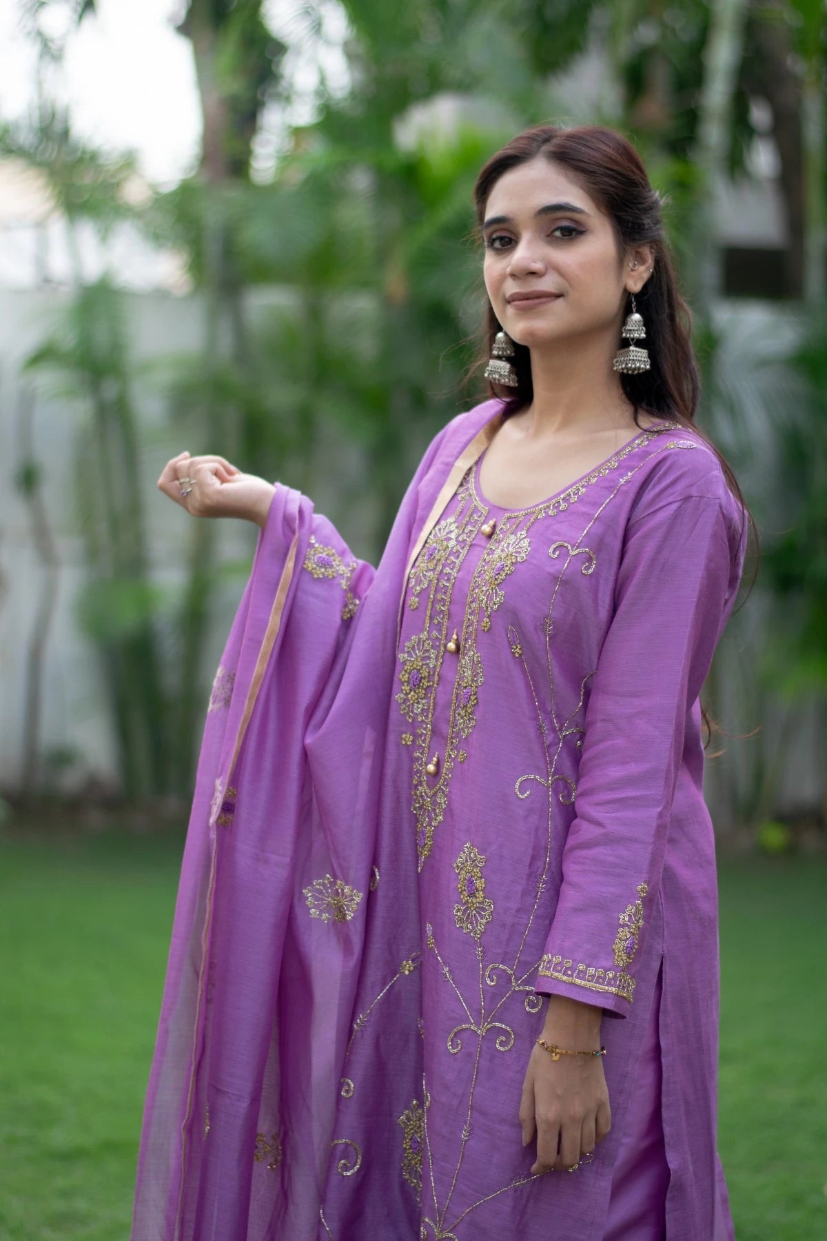 This image features a woman wearing a flowing purple lilac kurta with comfortable, loose-fitting trousers.