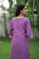 This picture captures a woman's fashion-forward outfit, which includes a stunning purple lilac kurta and chic trousers.