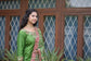 An Indian bridal outfit comprising a green silk gharara suit with exquisite kamkhab zardozi embroidery.