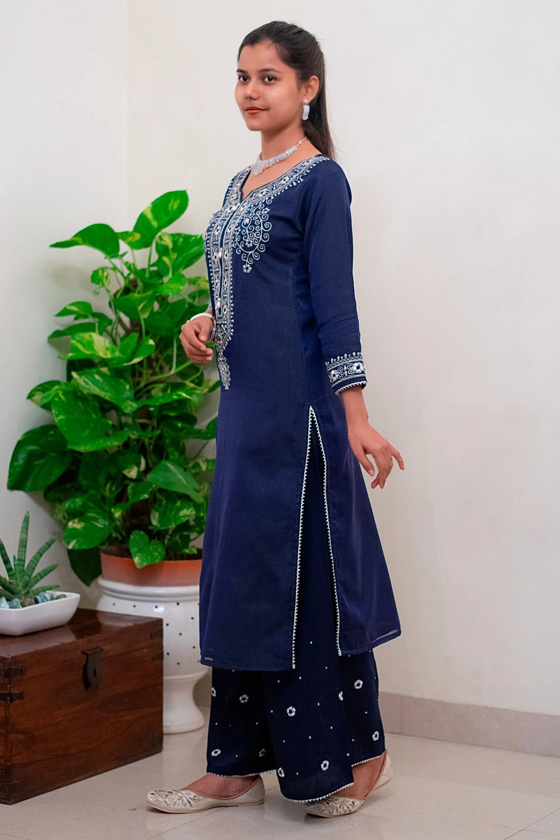 A group of women dressed in blue kurtas and dupattas, celebrating a cultural festival with traditional dance and music.