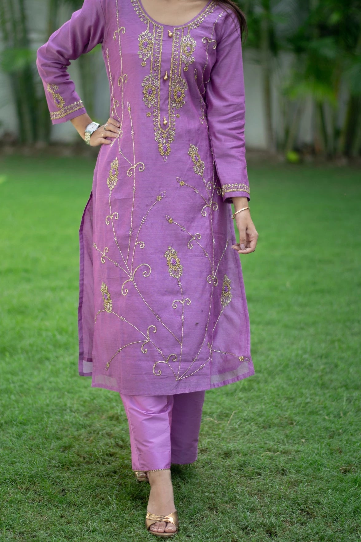 A woman is pictured wearing a sophisticated purple lilac cut dana kurta with tailored trousers.