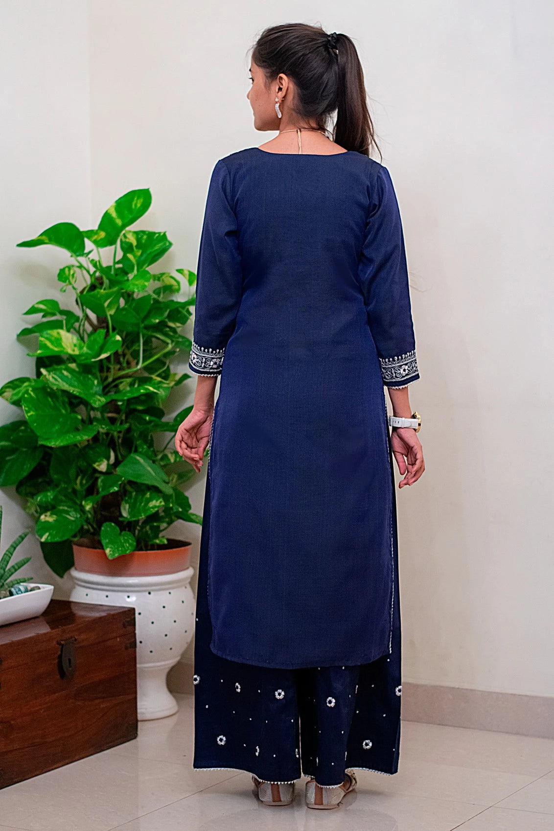 A young woman wearing a blue kurta and a printed blue dupatta, showcasing a contemporary take on traditional Indian fashion.